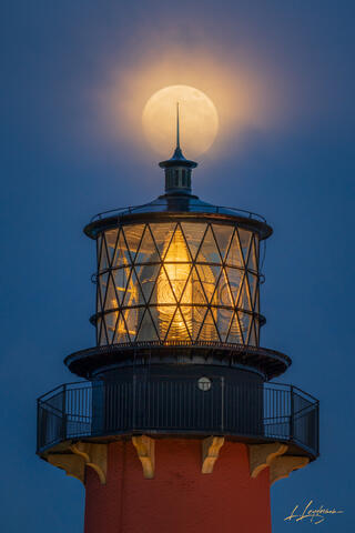 Full moon directly above Jupiter Lighthouse lantern room.