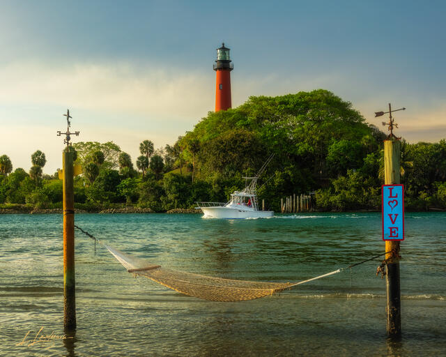 Jupiter Inlet lighthouse with hammock and fishing boat.