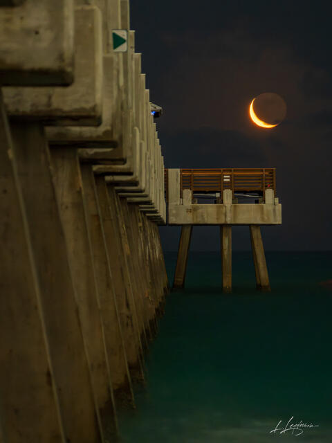 Crescent moon setting by Juno Beach Pier.