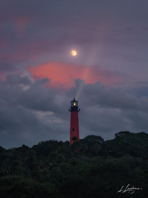 Glowing moon rising over the ocean at twilight near Jupiter, Florida.