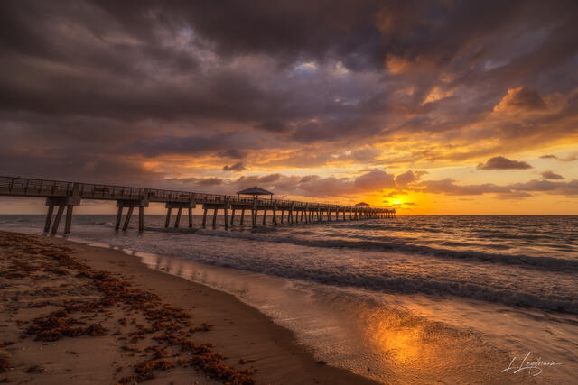 Crashing waves at sunrise near Juno Beach Pier, Florida.