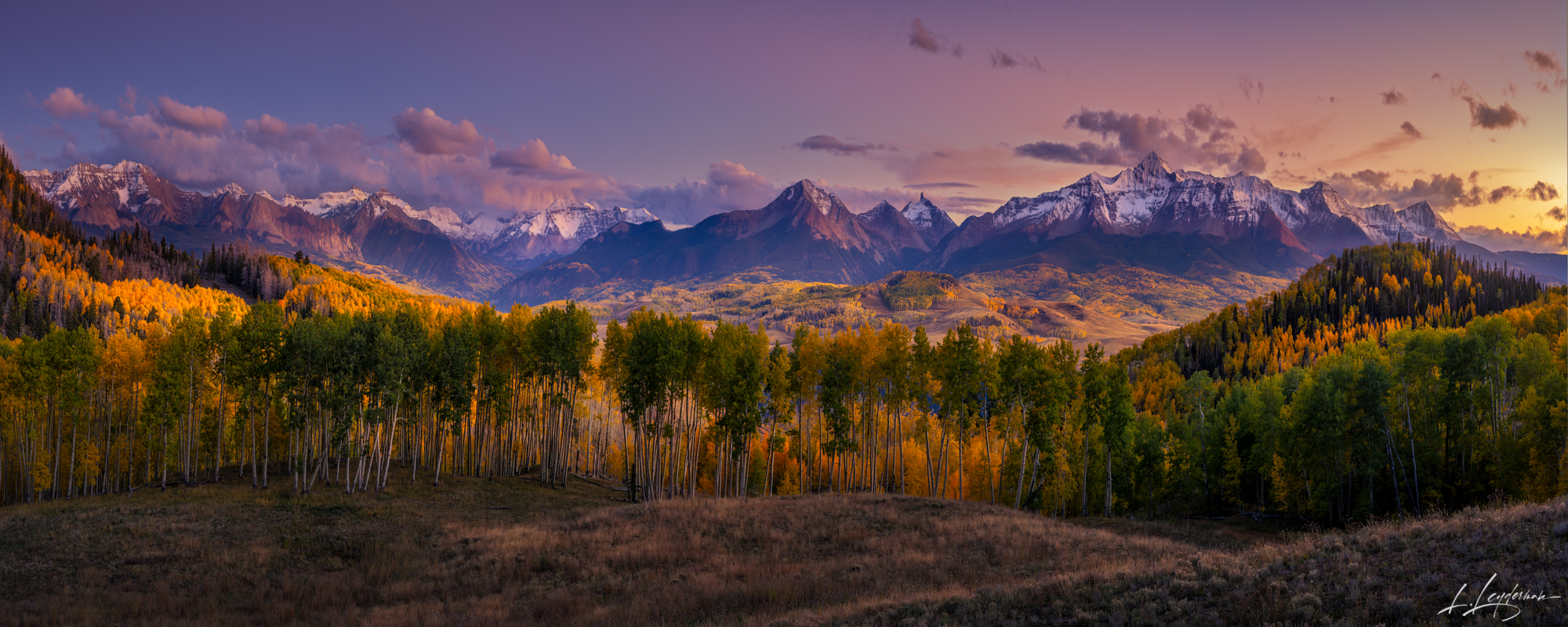 As the sun dips behind the rugged peaks, a wave of aspens – each like a lollipop with swirls of gold and amber – sweeps across...
