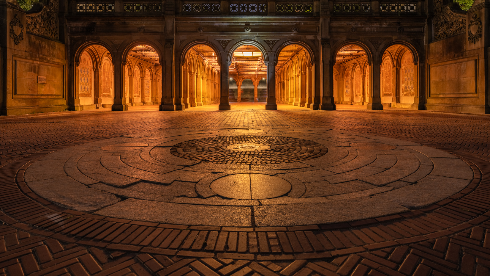The Bethesda Terrace, emptied of its daily visitors, stands under the cover of midnight. In the silence, each stone and archway...