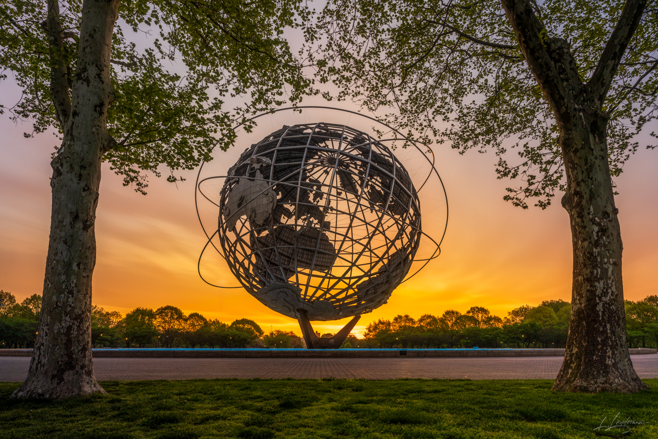 In Flushing Meadow, dawn's embrace,Unisphere stands in quiet grace,Spring's warm glow on steel and sphere,A world united, morning...