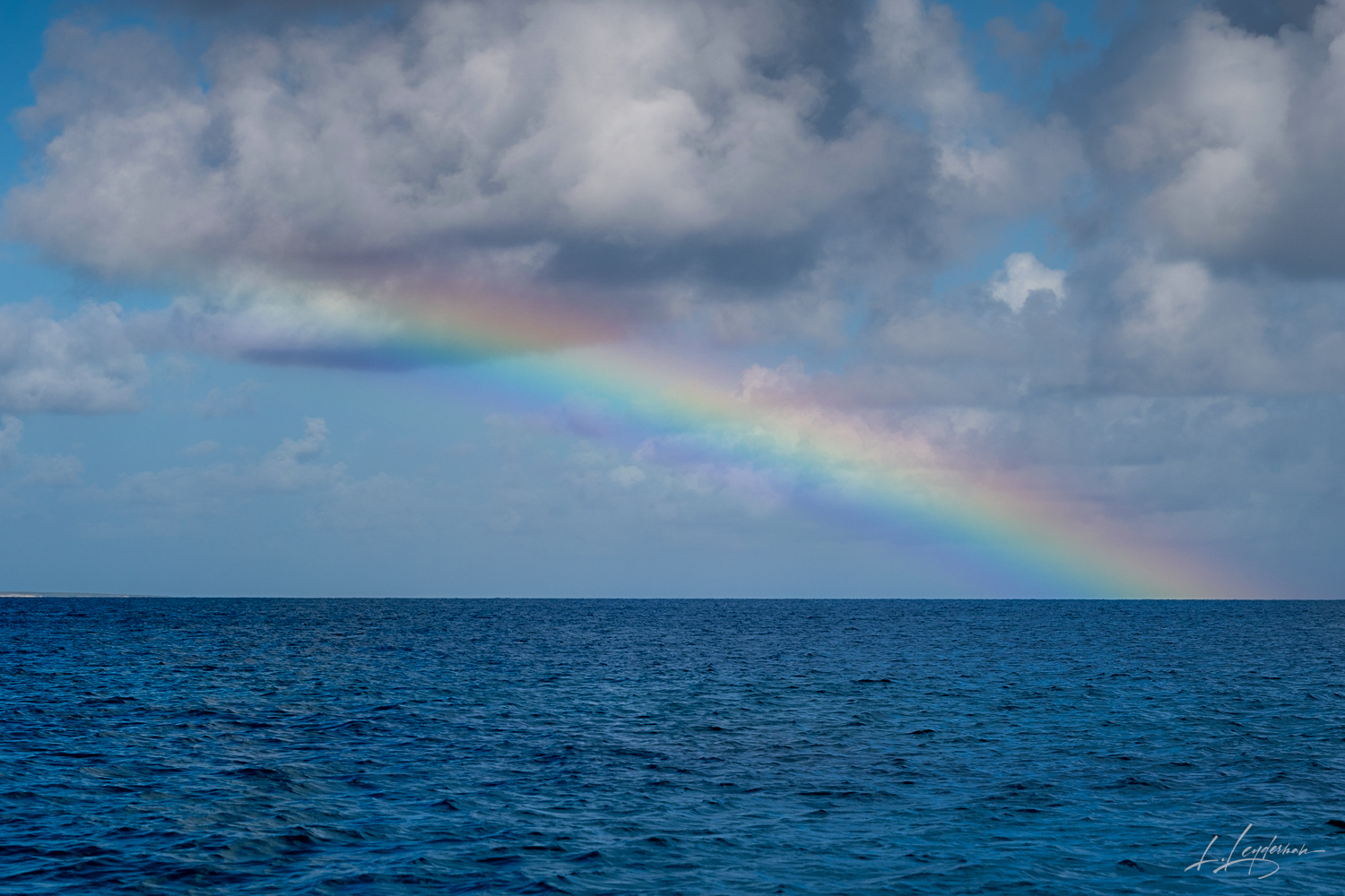 In this nautical dreamscape, a rainbow is the celestial navigator, charting a course through clouds and over waves. It's a beacon...